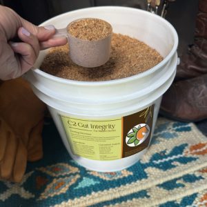 Bucket of C2 Gut Integrity hindgut supplement for horses, pictured with scoop
